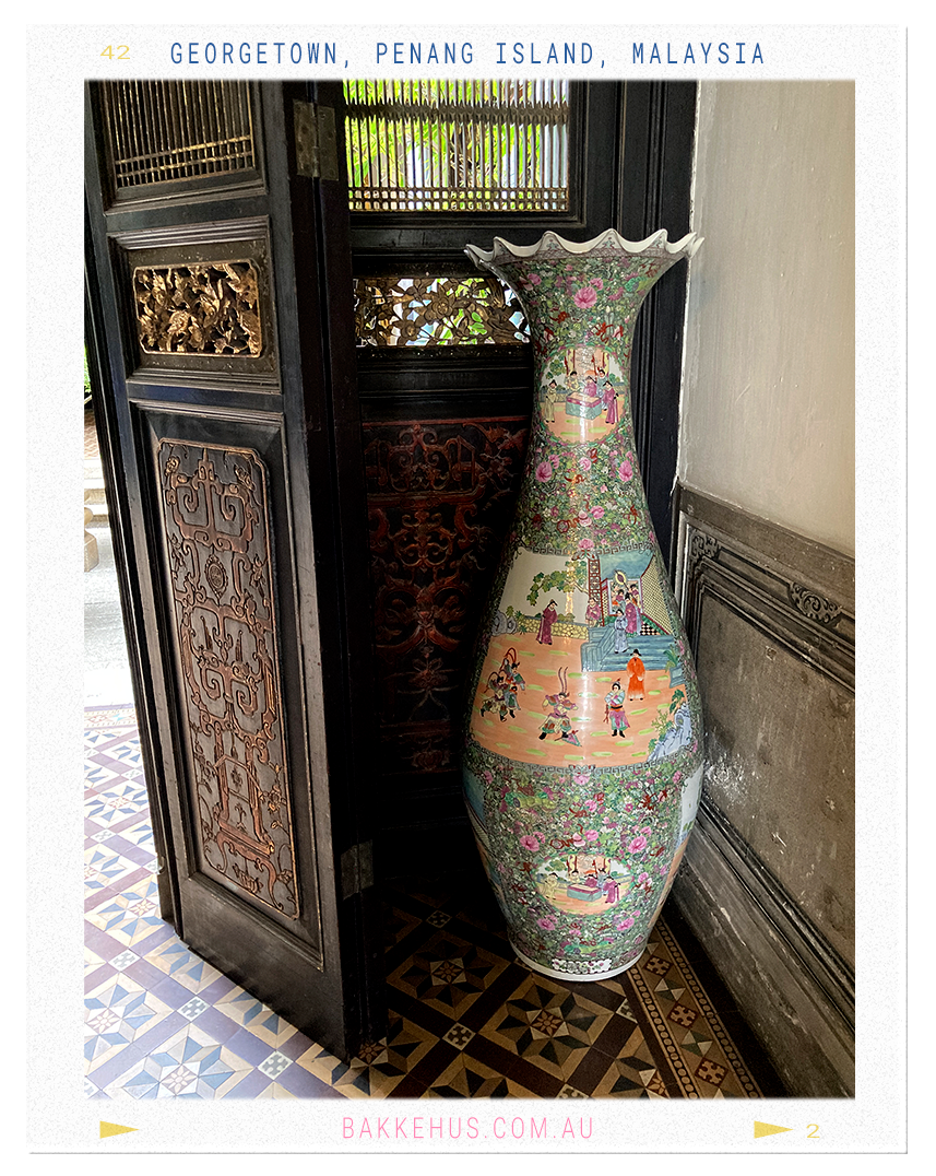 Close-up of vibrant Art Nouveau stained glass windows at the Blue Mansion in George Town, Penang, Malaysia, featuring floral-inspired motifs in green, blue, and lavender tones—highlighting the mansion’s East-meets-West architectural style. © Heidi Isaksen-Loxton for bakkehus.com