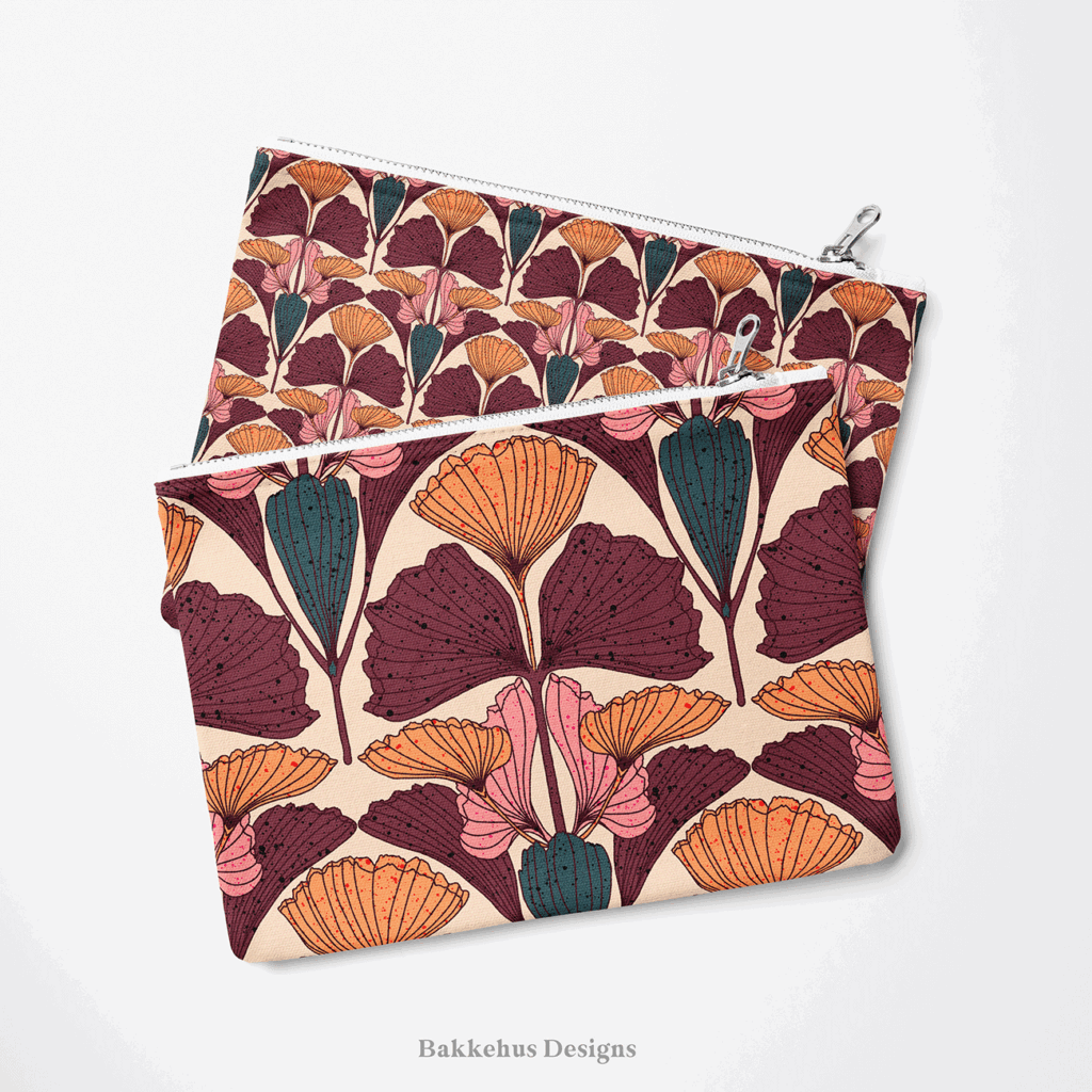 Two zip pouches made from Art Nouveau Ginkgo Fan fabric, one lying on the other, printed with plum, burnt orange and pink ginkgo leaves on beige.