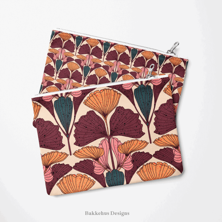 Two zip pouches made from Art Nouveau Ginkgo Fan fabric, one lying on the other, printed with plum, burnt orange and pink ginkgo leaves on beige.