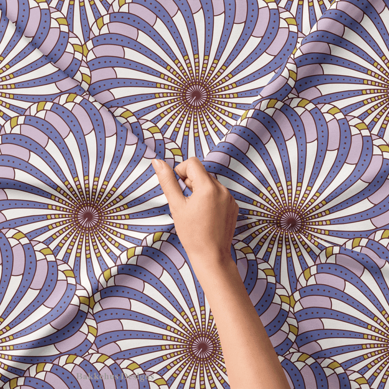 Close-up of a hand lifting Retro Gatsby Disco fabric, showing the detail of the cornflower blue and lilac scallop fans: radiating stripes, rows of tiny dots and small accent tiles around each fan edge.