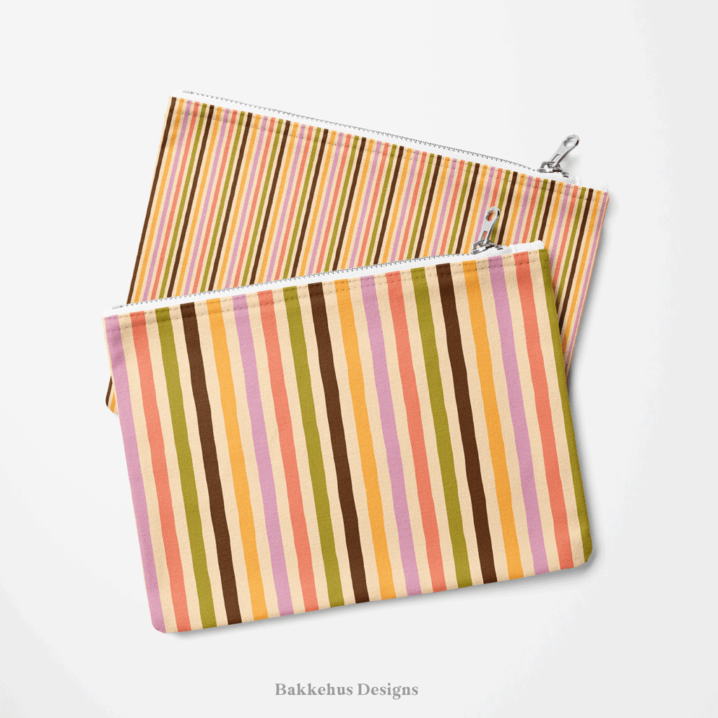 Two zip pouches made from Organic Narrow Stripe fabric, one lying on the other, printed with narrow hand drawn stripes in earthy retro colours.