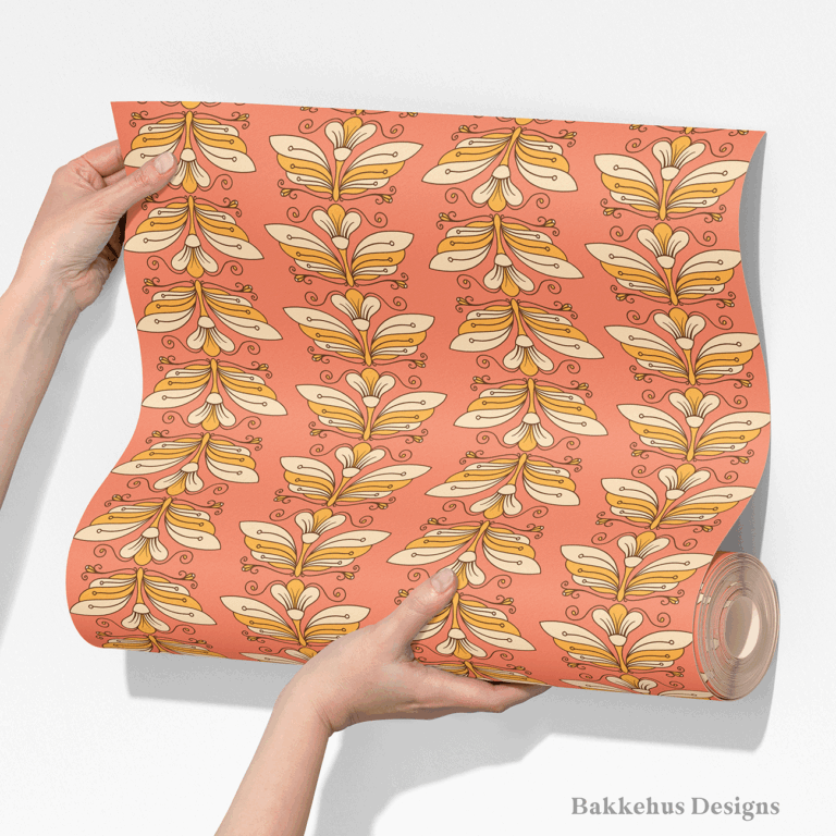 Two hands unroll a length of Retro Flower Moth Stripe wallpaper, showing the vertical columns of cream and gold flower moths on a coral ground.