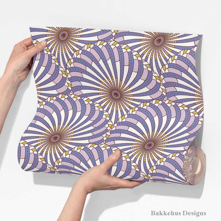 Two hands unroll a length of Retro Gatsby Disco wallpaper, showing how the large-scale cornflower blue and lilac scallop fans repeat across the width.