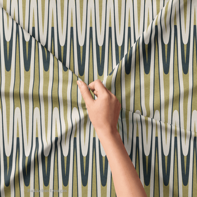 Close-up of a hand lifting Retro Wavy Stripe fabric, showing the olive green and charcoal looping waves and thin vertical lines that create a subtle optical effect.