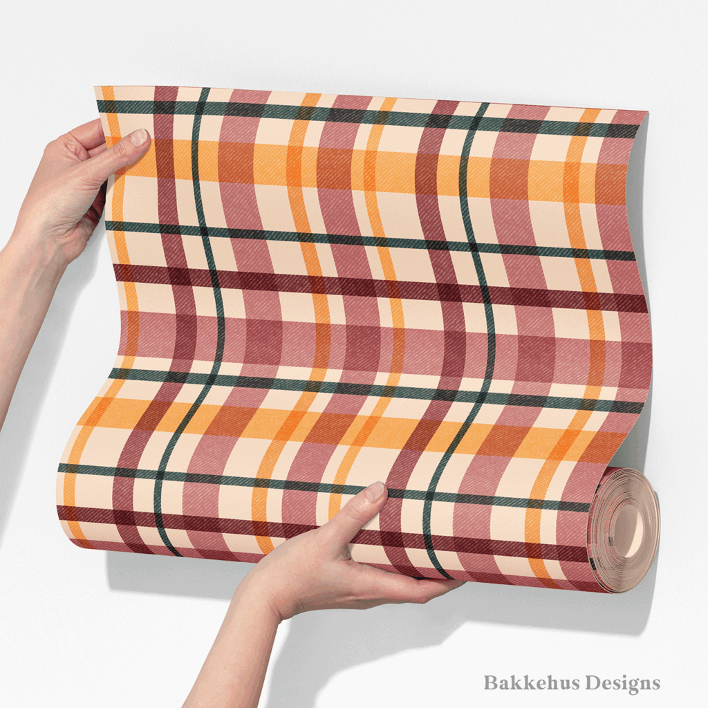 Two hands unroll a length of Textured Windowpane Plaid wallpaper, showing large teal, burgundy, mauve and burnt orange windowpane checks on warm beige.