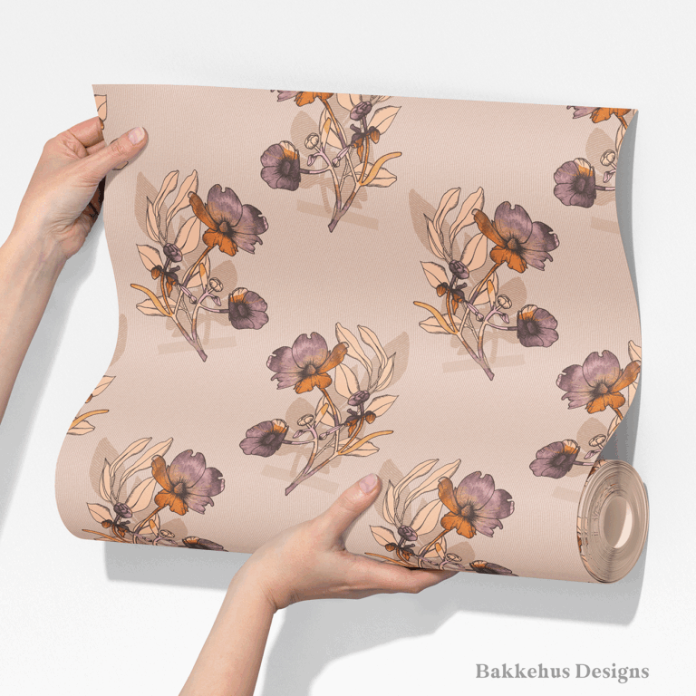 Two hands unroll a length of Vintage Buttercup Floral wallpaper, showing scattered ranunculus sprigs in mauve, plum and rust on a warm blush background.