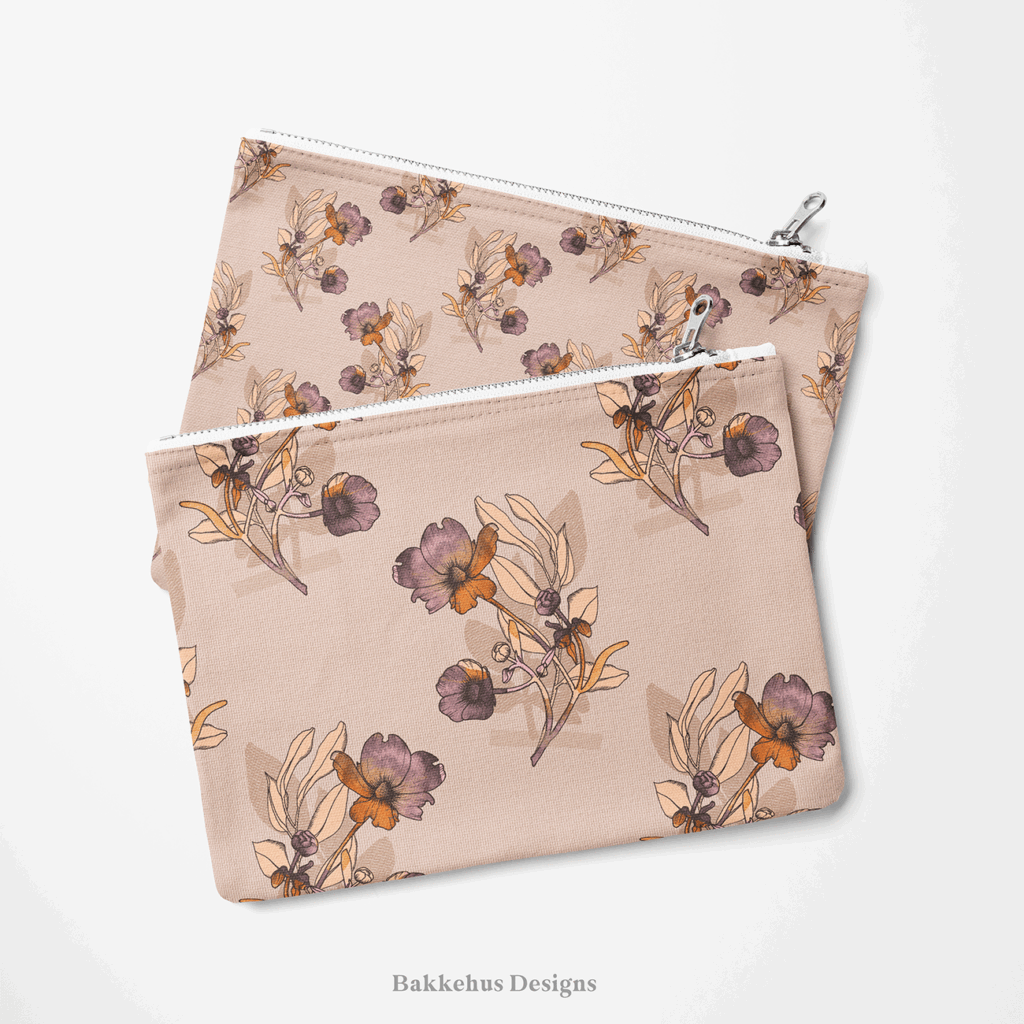 Two zip pouches made from Vintage Buttercup Floral fabric, one lying on the other, printed with hand-drawn ranunculus sprigs in mauve, plum and rust on blush.